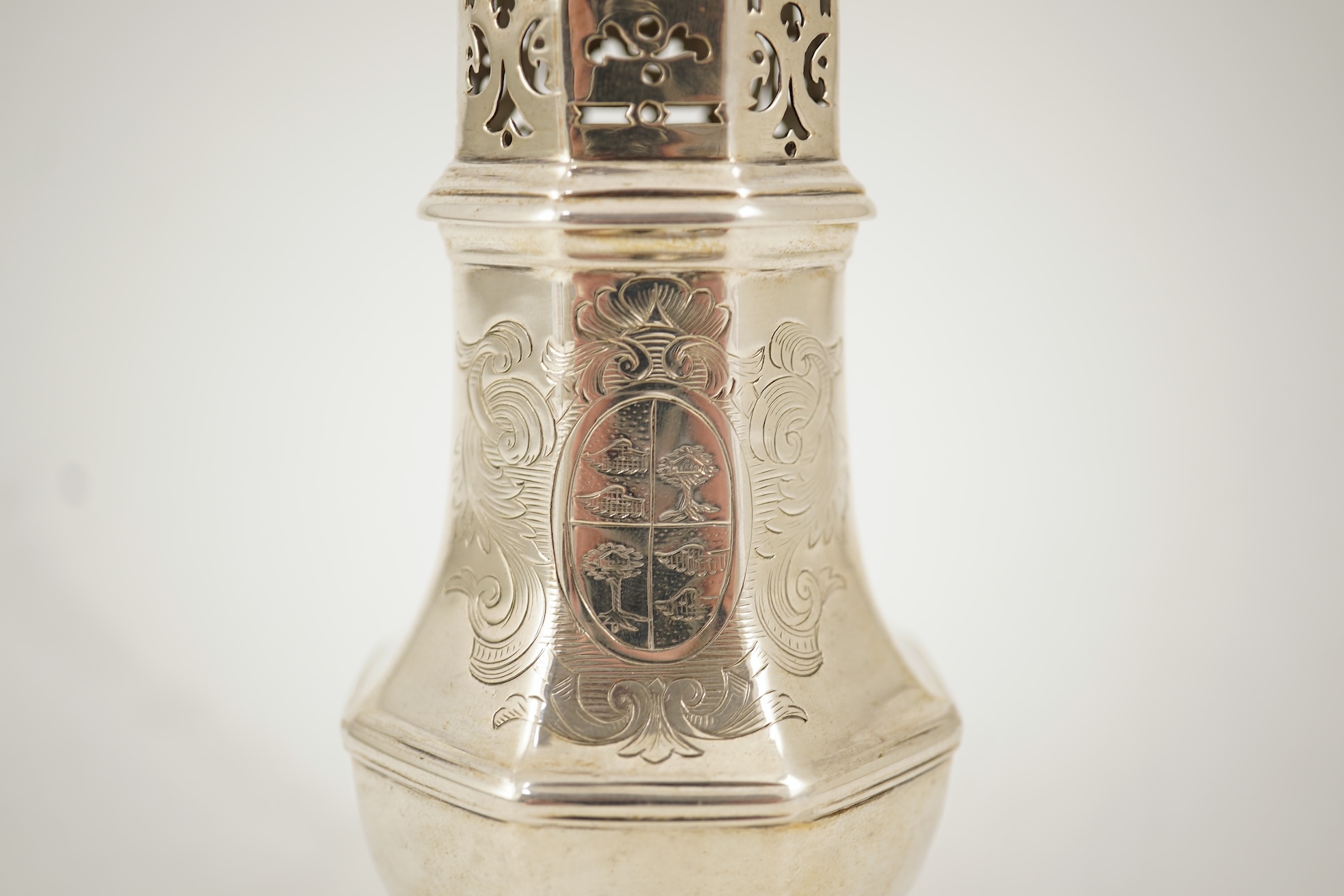 A late George I silver octagonal sugar caster, maker's mark overstruck by the date letter, with engraved armorial, London, 1725, 14.6cm, 4.6oz.